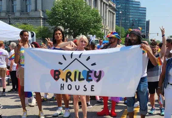 B. Riley House staff and supporters gathering at a Pride community event